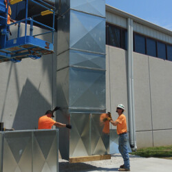Rouse workers installing a steel duct vent